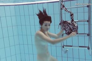 Beautiful brunette hair white white wife beneath water in the pool