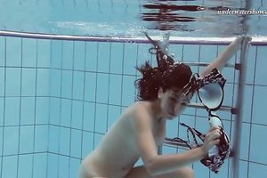 Beautiful brunette hair white white wife beneath water in the pool