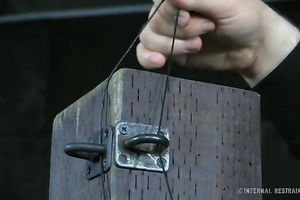 White wench chained to the post in sitting position
