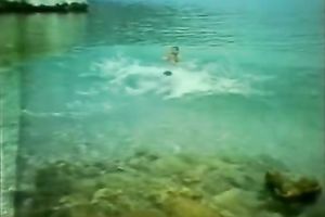 Playful and restless playgirl riding on her paramour on the beach