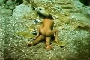 Playful and restless playgirl riding on her paramour on the beach