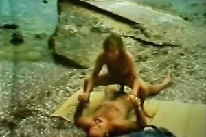 Playful and restless playgirl riding on her paramour on the beach