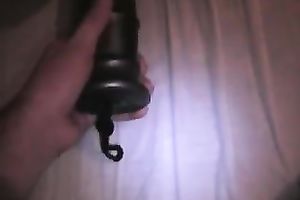 Large dark plastic sex toy permeating her taut vagina