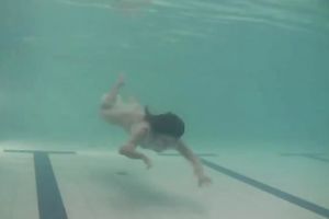 Sensational and juvenile dark brown chick in white dress undrewater