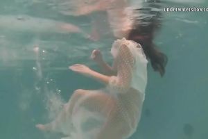 Sensational and juvenile dark brown chick in white dress undrewater