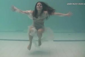 Sensational and juvenile dark brown chick in white dress undrewater