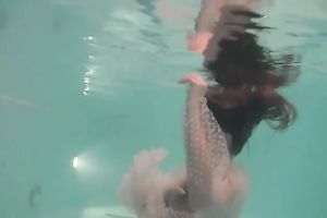 Sensational and juvenile dark brown chick in white dress undrewater