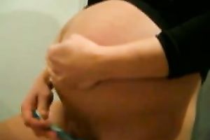 Pregnant dilettante girlfriend shaving her twat in front of the mirror