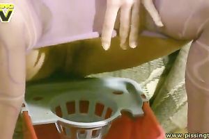 Slim titless pale brunette hair takes off hose to pee into the bucket