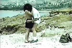 Classic brunette hair with petite bra buddies blowing wang on the beach