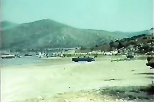 Classic brunette hair with petite bra buddies blowing wang on the beach