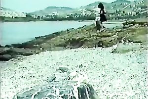 Classic brunette hair with petite bra buddies blowing wang on the beach