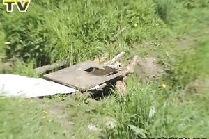 Looking like an alien pale redhead in yellow suit voids urine outdoors