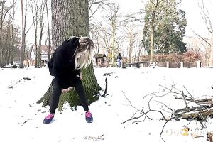 Blonde sweetie in dark thermal panties urinates in the park