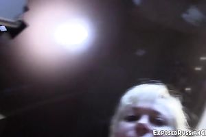 Busty golden-haired Russian woman in the kitchen flashing her goodies