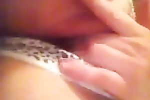 Playing with my muff by rubbing and fingering it through her pants