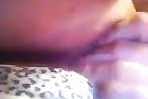 Playing with my muff by rubbing and fingering it through her pants