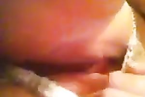 Playing with my muff by rubbing and fingering it through her pants