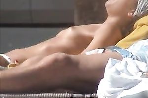 Spying on sultry Spanish brunette hair tanning her body topless