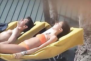 Spying on sultry Spanish brunette hair tanning her body topless