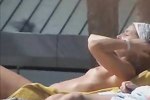 Spying on sultry Spanish brunette hair tanning her body topless