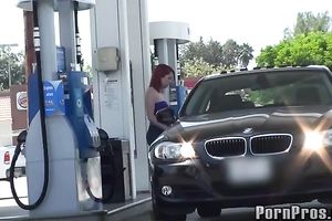 Sassy redhead golddigging bimbo pumping gas in her bimmer