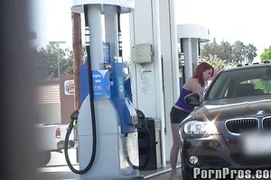Sassy redhead golddigging bimbo pumping gas in her bimmer