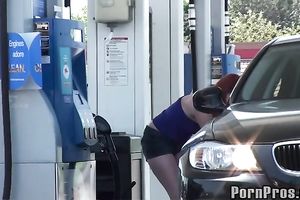 Sassy redhead golddigging bimbo pumping gas in her bimmer