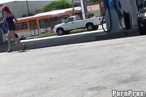 Sassy redhead golddigging bimbo pumping gas in her bimmer