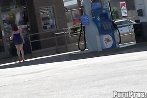 Sassy redhead golddigging bimbo pumping gas in her bimmer