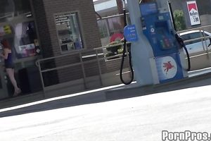 Sassy redhead golddigging bimbo pumping gas in her bimmer