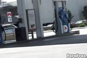 Sassy redhead golddigging bimbo pumping gas in her bimmer