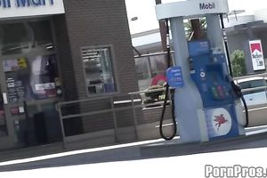 Sassy redhead golddigging bimbo pumping gas in her bimmer