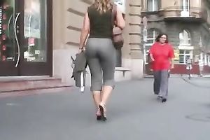 Sexy playgirl in tight trousers walking down the streets