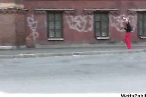 Her red constricted jeans are warm and wet after pissing