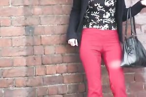 Her red constricted jeans are warm and wet after pissing