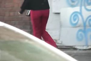 Her red constricted jeans are warm and wet after pissing