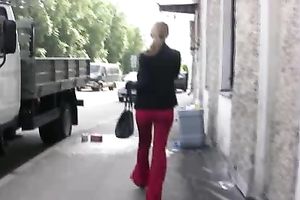 Her red constricted jeans are warm and wet after pissing