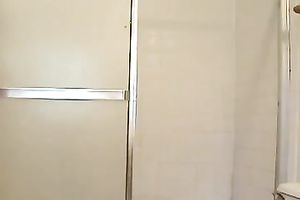 Brunette milf flashes her hairy slit whilst taking a shower