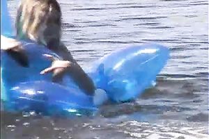 Attractive brunette hair chick with well shaped body swims i the lake