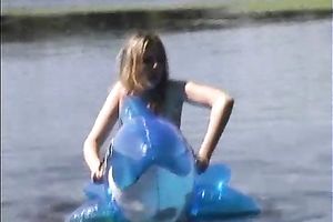 Attractive brunette hair chick with well shaped body swims i the lake