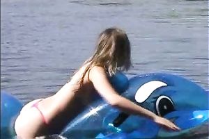 Attractive brunette hair chick with well shaped body swims i the lake