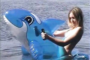 Attractive brunette hair chick with well shaped body swims i the lake