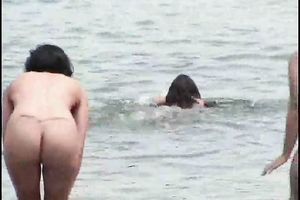 Two curvy Latina women expose their large booties on the stripped beach
