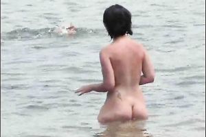 Two curvy Latina women expose their large booties on the stripped beach