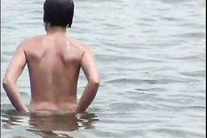 Two curvy Latina women expose their large booties on the stripped beach