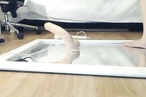 Brunette skank toys her muff whilst sitting on a mirror