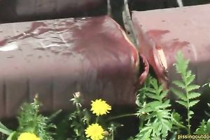 Nasty dark brown babe makes water on the chair left outdoors