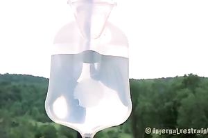 Slender brunette hair floozy bounded in cage outdoors acquires a toy in her booty aperture