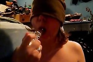 Blindfolded nympho sucks her gllassd marital-device like a dick